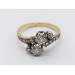 18K (tests as) yellow gold diamond cross-over ring. Two Brilliant 0.15 carat diamonds - Approx -