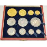 An 1887 Queen Victoria Gold and Silver Coin Set. Gold coins: A 22K £5 Gold Coin. A 22K Gold £2 Coin.
