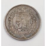 An 1823 George IV Silver Half Crown Coin. 14.12g Condition as per photos.