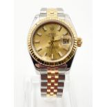 A LADIES ROLEX OYSTER PERPETUAL DATEJUST IN BI-METAL WITH GOLD FACE. 26MM