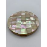 Vintage Stratton compact having shaded mother of pearl lid with attractive star design chase work to