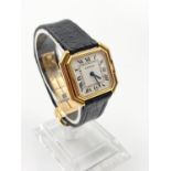 A LADIES I8K GOLD CARTIER WATCH IN OCTAGONAL TANK STYLE , WITH ROMAN NUMERALS AND MANUAL MOVEMENT.