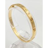 A CARTIER 18K GOLD BANGLE WITH THE CARTIER CERTIFICATE .35gms