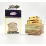 A pair of retro table lighters, one features an oyster with a pearl set in clear resin, and the