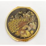 A Vintage Japanese Ladies Compact. Embossed gilded Peacock decoration on lid. Good condition. 7cm