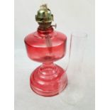 A Vintage Red Glass Kerosene Oil Lamp with Wicker Turner. As found. 51cm tall