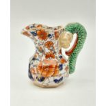 A Vintage Masons Ironstone Creamer Jug. Serpent-esque handle. Floral decoration. Mark on base.