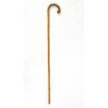 AN ANTIQUE CURVED BAMBOO WALKING STICK 91cms in height