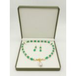 A beautiful pale green jade and baroque pearls necklace and earrings set. Adorned with cubic
