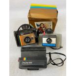Three POLAROID cameras. A One step 600 model, another one with adjustable parts in original box