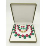 A substantial tear-drop emeralds and oval rubies necklace and earrings set with a Cartier style