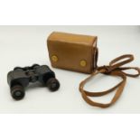 A Pair of Small Vintage Trinityte Binoculars. 9 x 8cm Comes in a leather case.