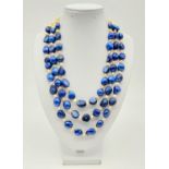 A rarely seen, three rows of blue and white pearls necklace in a presentation case. Necklace length: