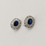 A Pair of Stunning 18K White Gold, Diamond and Sapphire Earrings. Each earring contains 12