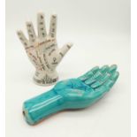 Two ceramic hands. One is a chiromancy model, titled : The map of the hand, used extensively in