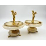 A PAIR OF VINTAGE ONYX ASH TRAYS. 12cms DIAMETER AND 14 CMS TALL A/F