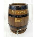 A WOODEN PORT BARREL WITH METAL TAP. 36cms TALL 35cms CIRCUMFERENCE