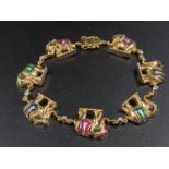 A Stunning 18K Yellow Gold Diamond and Precious Gem Elephant Bracelet. Hand-crafted with 20