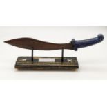 A Commemorative Gurkha Kukri with Bronze Blade and Lapis Luzuli Hilt. Comes on a wooden presentation