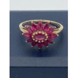 Ladies 9 carat GOLD and Topaz cluster ring.Having pink Topaz in flower formation with gold bead