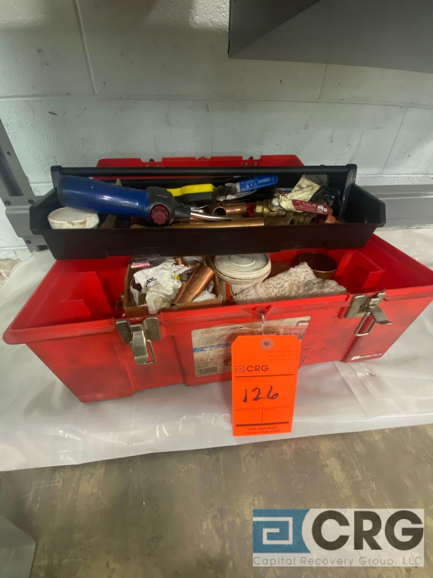 Plumbers tool box with assorted plumbing tools, pieces and materials, including bernzomatic torch