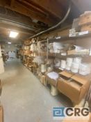 Lot of assorted catering store room contents on shelves, including paper containers, plastic