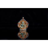 Arte Himalayana A Rana style gold plated pendant portraying Green Tara encrusted with coral, turquo