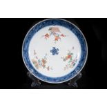 Arte Cinese A porcelain dish painted with polychrome flowers China, Ming period or later .