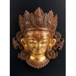 Arte Himalayana A gilded copper plaque embossed with the face of Avalokiteshvara Nepal, Malla perio