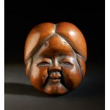 ARTE GIAPPONESE A wooden netsuke carved with a lady's faceJapan, 19th century .