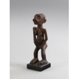 Arte africana A wooden sculpture of a standing woman Equatorial Africa.