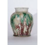 Arte Cinese A Sancai style vase moulded with floral motifs and glazed with dashes of green strainsC