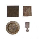 Arte Islamica A group of three talismanic metal plaques and a Cairoware small dish inlaid with silv