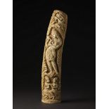 Arte Indiana A large ivory carving depicting a woman pouring among playing couples India, early 20t