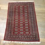 A pink ground rug, 155 x 97 cm, and a red ground Afghan type rug, 203 x 122 cm, and another 180 x