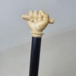 A walking stick, the ivory handle carved in the form of a clenched hand holding a scroll, engraved