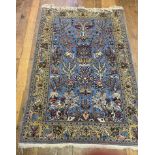 A Persian blue ground rug, main yellow border, centre decorated deer, beasts, birds and foliate