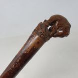 A folk art walking stick, with carved handle in the form of an elephant, 82 cm