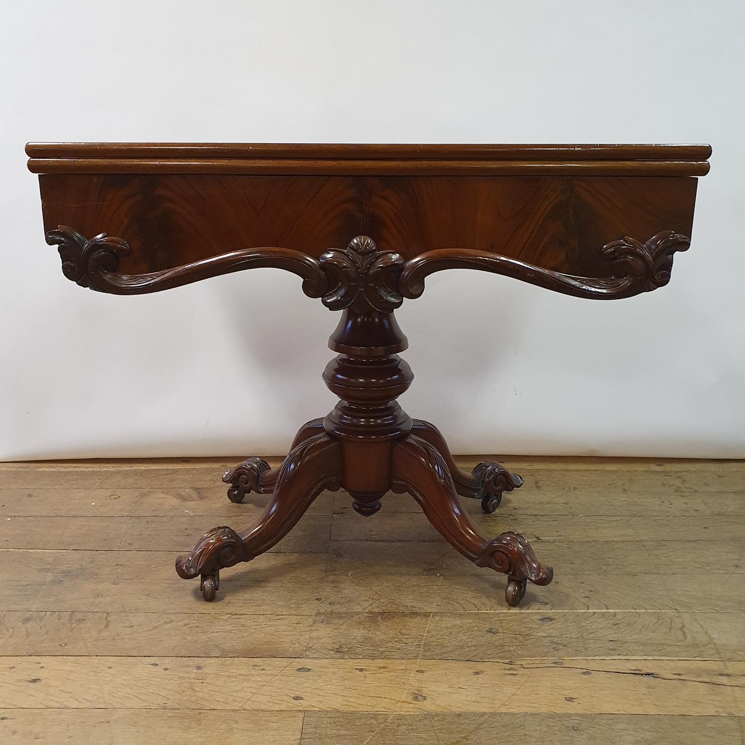 A Victorian mahogany tea table, on a turned column and four downswept legs, 96 cm wide, two