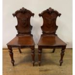 A pair of Victorian mahogany hall chairs, with cartouche shaped backs and turned front legs (2)