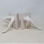 An amusing pair of 20th century porcelain bookends, in the form of legs, 17 cm high