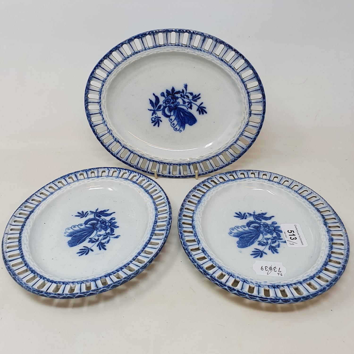 A set of three early 19th century blue and white oval dishes, with pierced rims, decorated