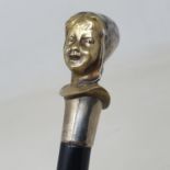 A walking stick, with cast metal handle in the form of a child, on ebonised shaft, 92 cm