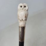 A 19th century walking stick, the ivory handle carved in the form of an owl, on ebony shaft, 97 cm