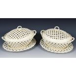 A pair of late 18th/early 19th century Leeds creamware basket and covers, on stands, 31 cm wide