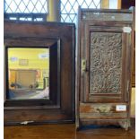A late Victorian carved oak smoker?s cabinet, 21.5 cm wide, and a 17th century style wall mirror,