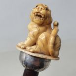 A 19th century walking stick, with carved ivory handle in the form of a tiger, on hardwood shaft, 95