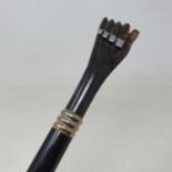A walking stick, with carved horn handle in the form of a hand, with silver coloured metal nails, 93