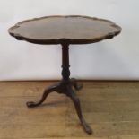 An 18th century style walnut table, on a column support and tripod base, 74 cm diameter