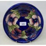 A Moorcroft pottery pansy pattern dish, 22 cm diameter